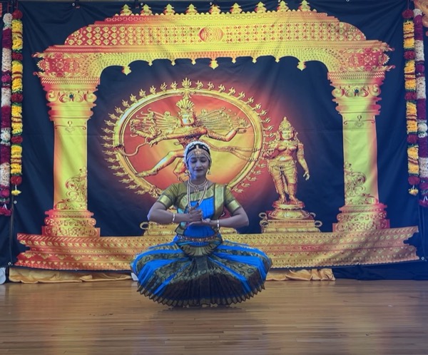 Dancer on stage before Nataraja backdrop
